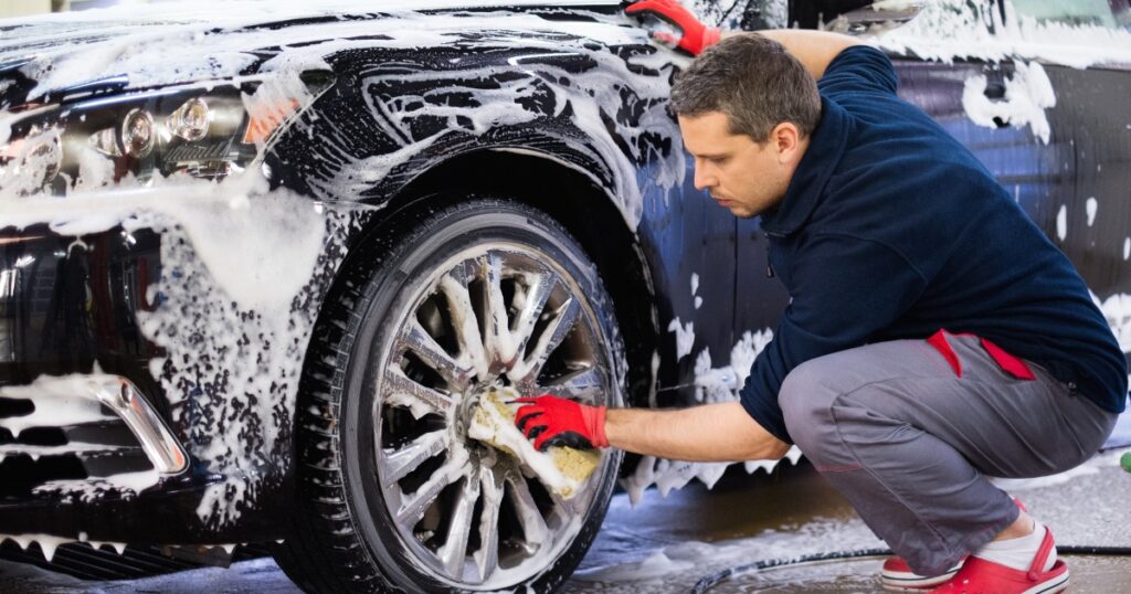 man washing car